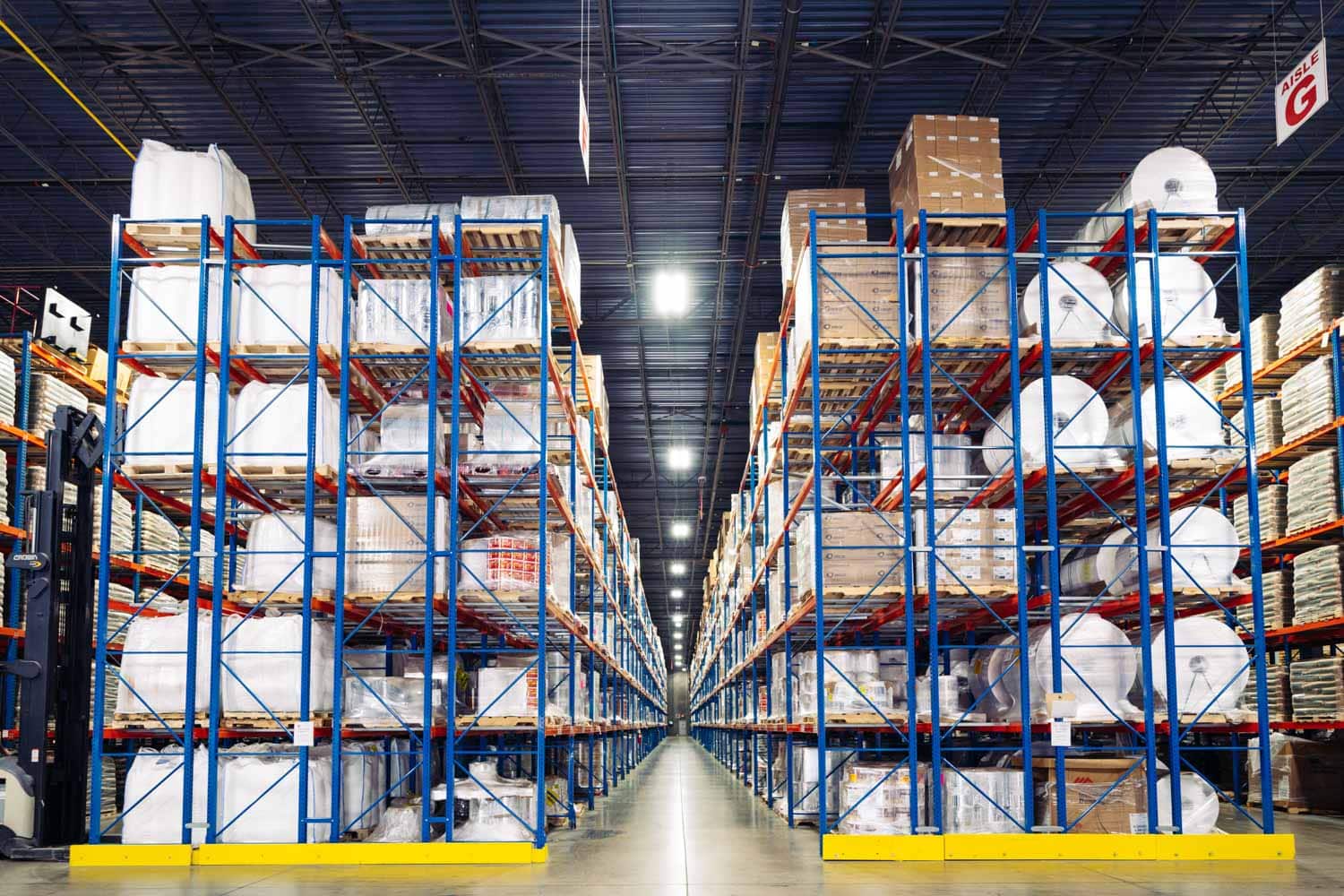 interior warehouse with racks full of product - Contact Distribution Technology