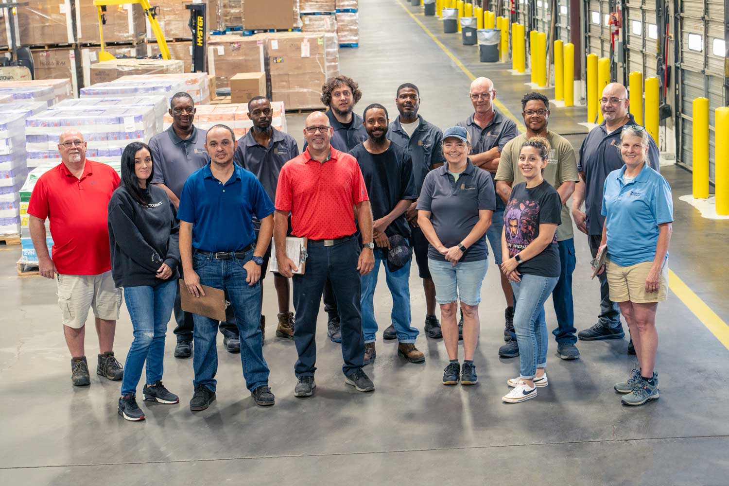 A group of 15 people standing in a warehouse - Contact Distribution Technology